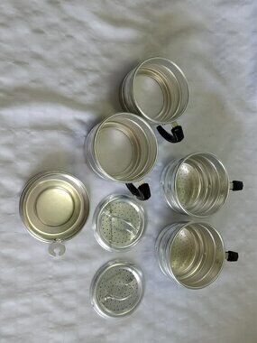 Set of vintage aluminum coffee filters and cups circa 1940